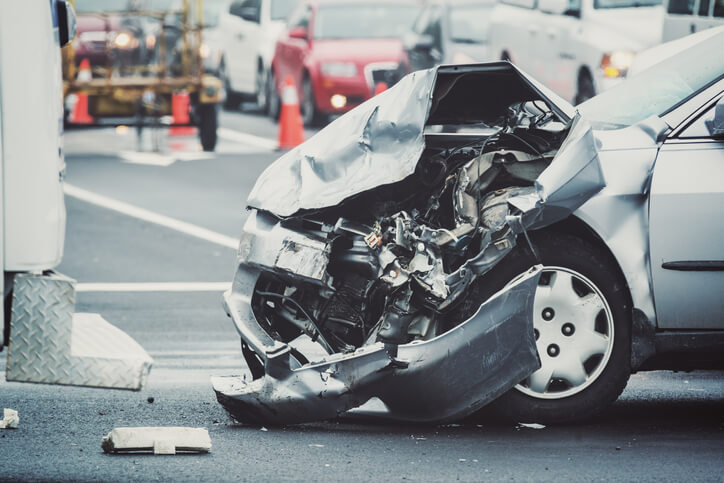 distracted driver causes a silver car to get its front side smashed in in crash