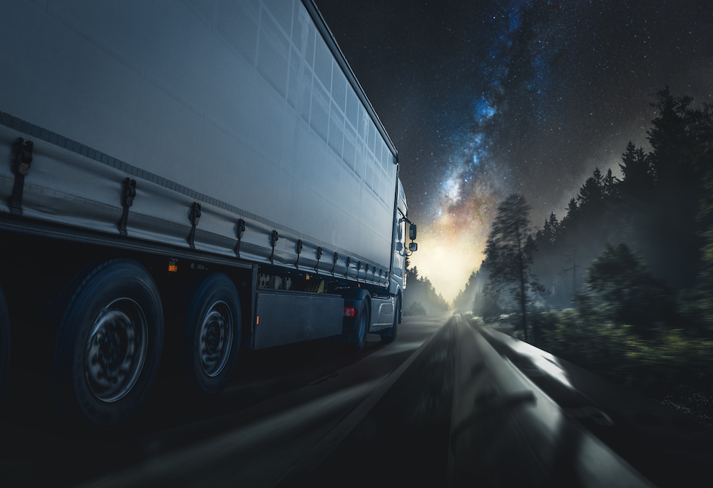 truck driving down a highway at night