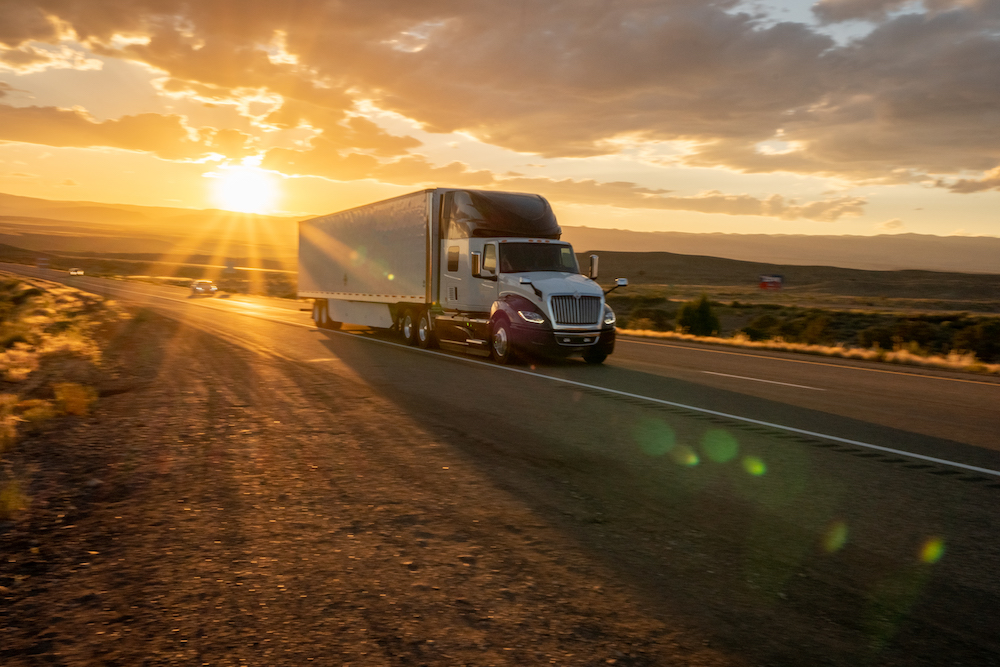 Big freight truck on the open highway heading to their destinations to make the deliveries