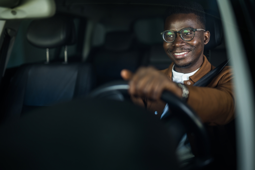 A driver smiling behind the wheel